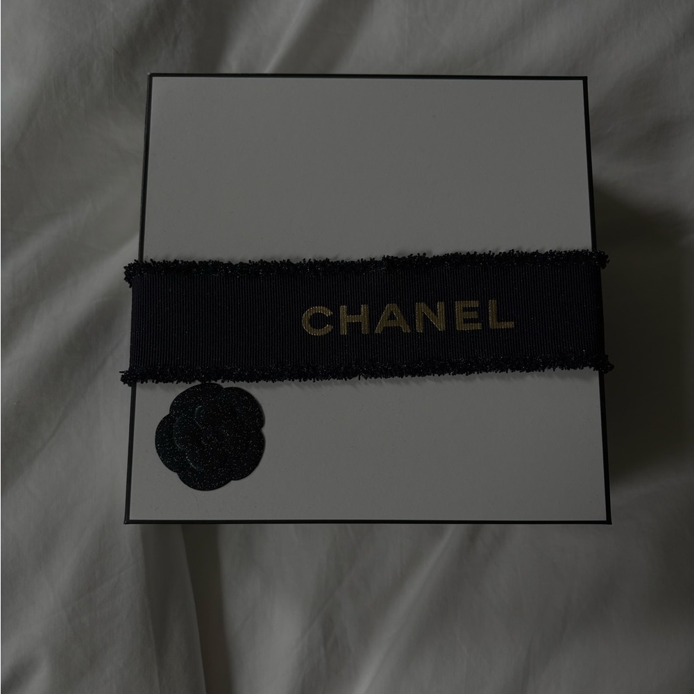 CHANEL Black Ribbon with Gold Logo Accent